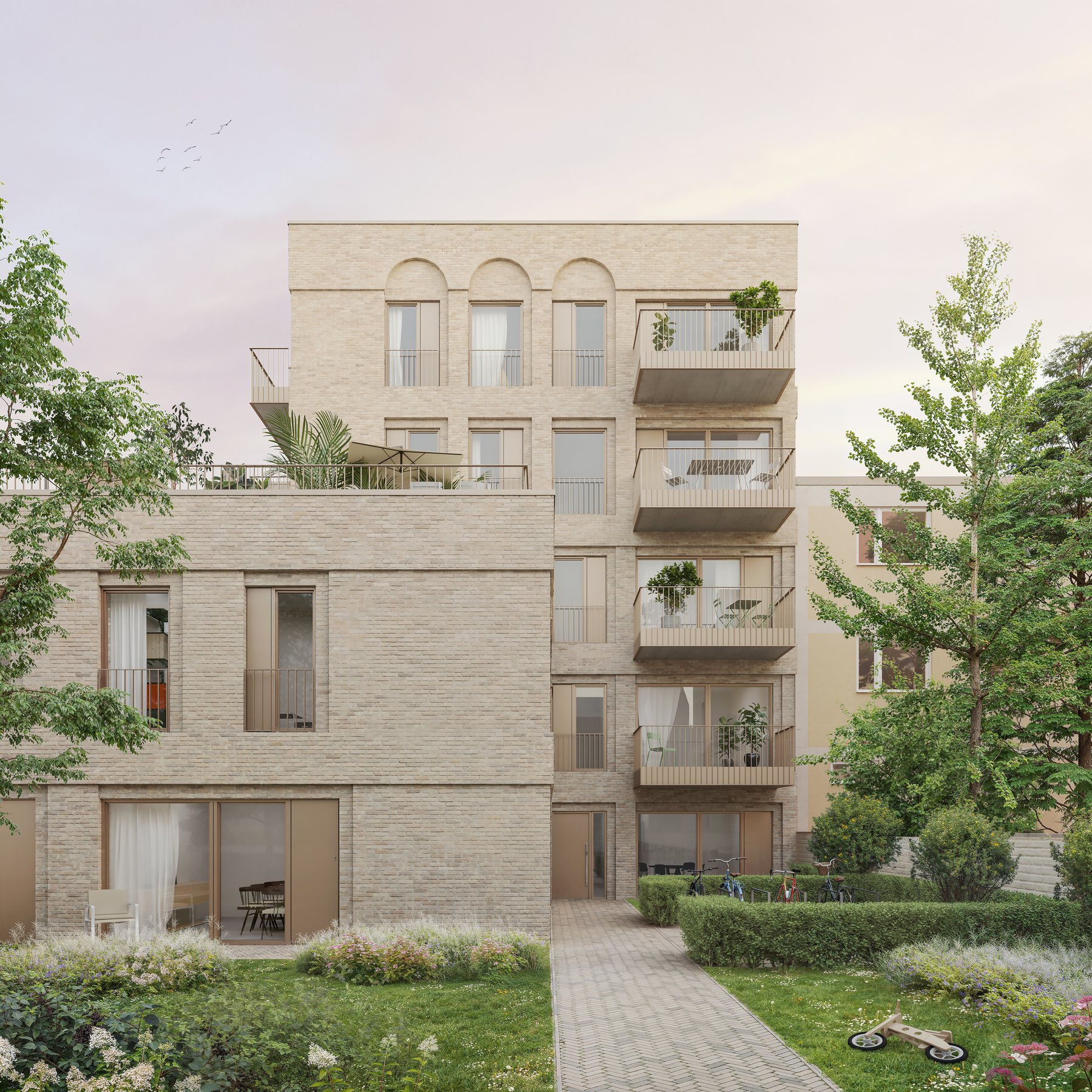 Moderner Wohnbau mit Balkonen und Gartenhof
